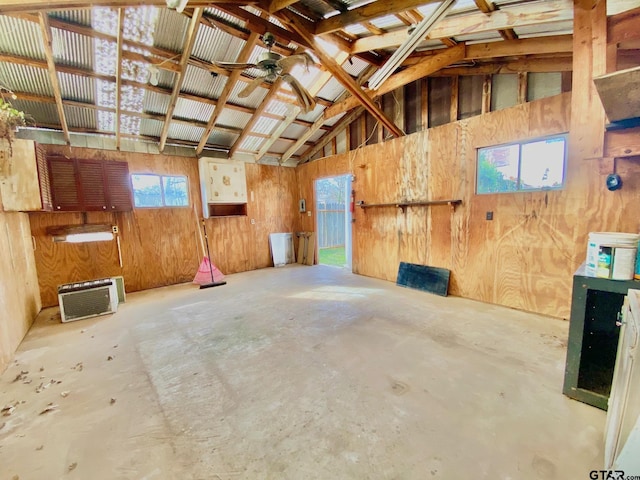 102 Gordon Dr, Crockett, TX 75835 - misc room with concrete floors, wooden walls, vaulted ceiling, ceiling fan, and a garage