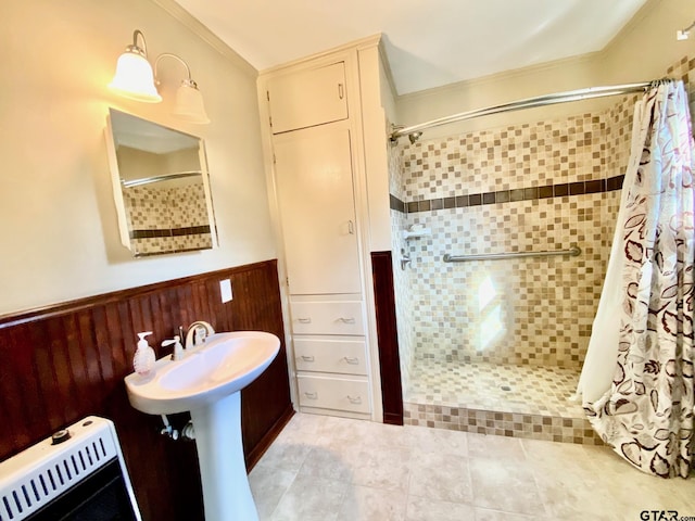102 Gordon Dr, Crockett, TX 75835 - bathroom with a shower stall, ornamental molding, a wainscoted wall, and tile patterned flooring