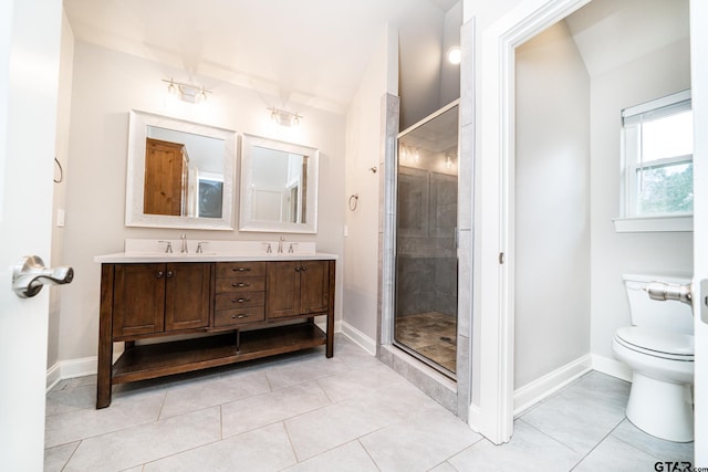 bathroom with tile patterned floors, vanity, a shower with shower door, and toilet