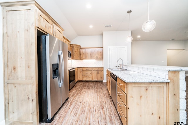 kitchen with decorative light fixtures, light brown cabinets, sink, and stainless steel appliances