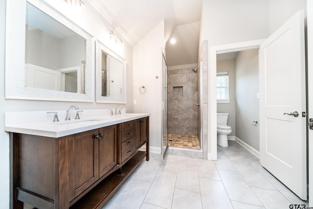 bathroom with tile patterned flooring, vanity, toilet, and a shower with door