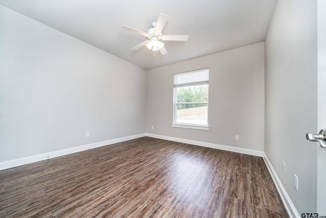 unfurnished room featuring ceiling fan and dark wood-type flooring