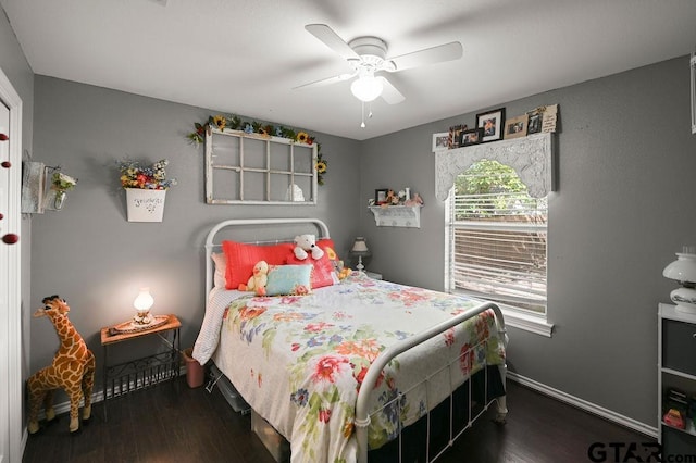 bedroom with ceiling fan and dark wood-type flooring