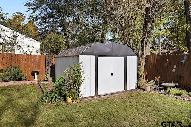 view of outdoor structure featuring a lawn