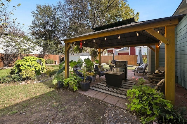 view of patio featuring a gazebo, area for grilling, and an outdoor hangout area