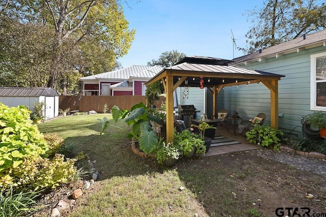 view of yard with a gazebo and a storage shed