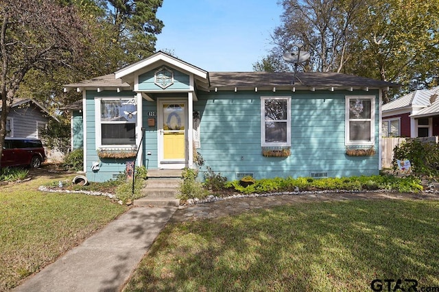 bungalow-style house featuring a front yard