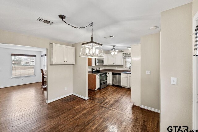 bedroom featuring a textured ceiling, ceiling fan, crown molding, and dark wood-type flooring