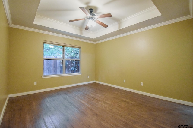 spare room featuring ornamental molding, hardwood / wood-style flooring, ceiling fan, and a tray ceiling