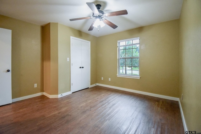 empty room featuring hardwood / wood-style flooring and ceiling fan