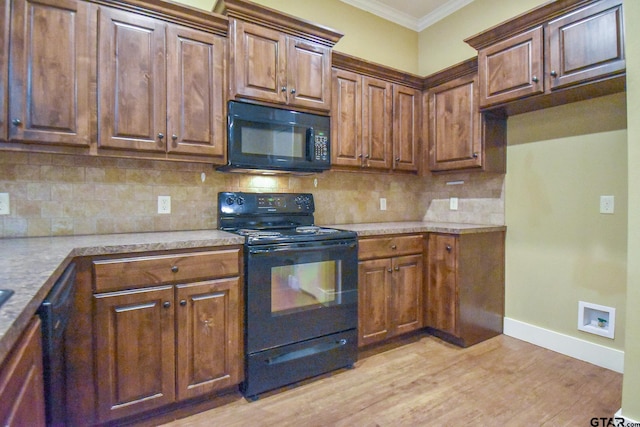 kitchen featuring black appliances, tasteful backsplash, ornamental molding, and light hardwood / wood-style flooring