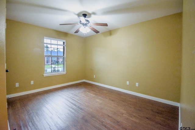 spare room featuring wood-type flooring and ceiling fan