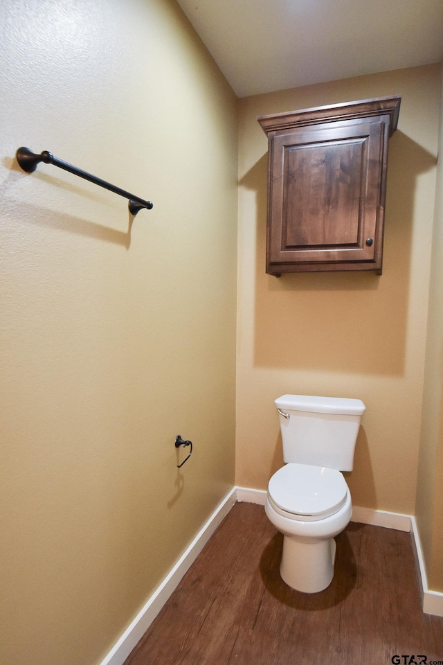 bathroom with hardwood / wood-style floors and toilet