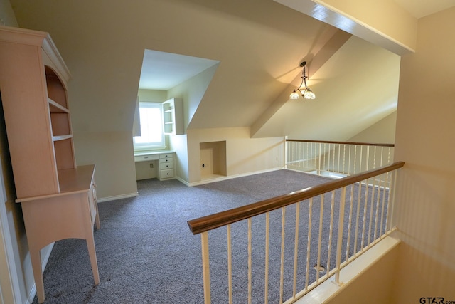 bonus room with vaulted ceiling, carpet floors, and an inviting chandelier