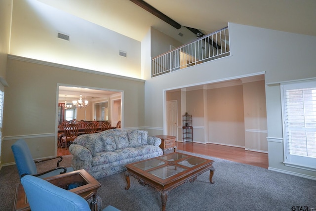 living room featuring an inviting chandelier, beam ceiling, high vaulted ceiling, and carpet