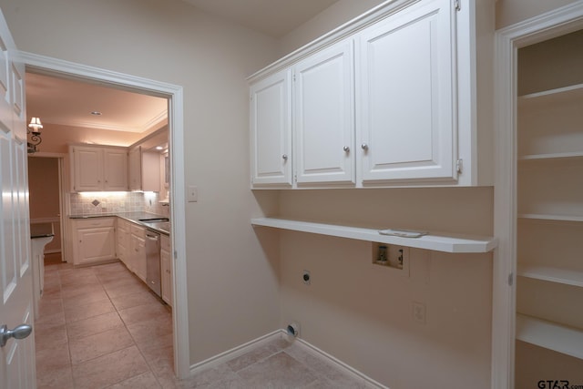 laundry area featuring cabinets, ornamental molding, washer hookup, light tile patterned floors, and hookup for an electric dryer