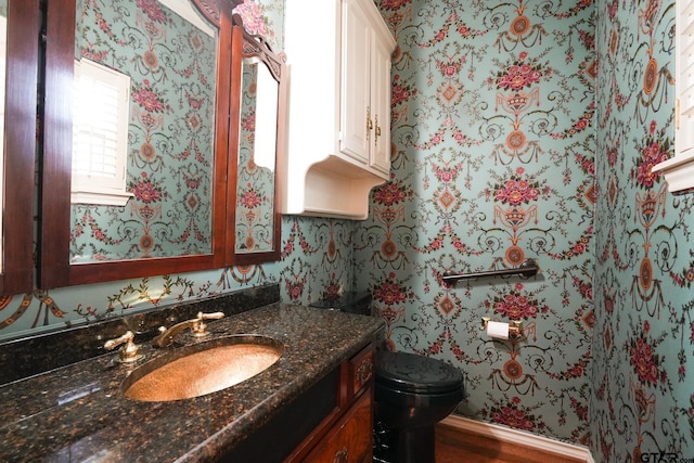 bathroom featuring vanity and toilet