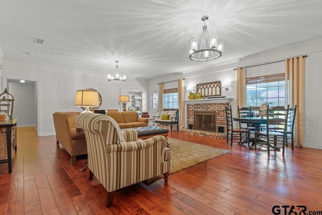 1805 Greenway St, Gilmer, TX 75644 - living area featuring a chandelier, crown molding, plenty of natural light, hardwood / wood-style flooring, and a fireplace