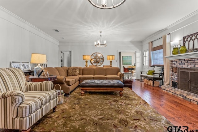 1805 Greenway St, Gilmer, TX 75644 - living area with a chandelier, hardwood / wood-style floors, a fireplace, and crown molding