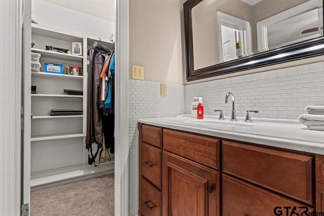 1805 Greenway St, Gilmer, TX 75644 - bathroom featuring vanity, a spacious closet, and a wainscoted wall