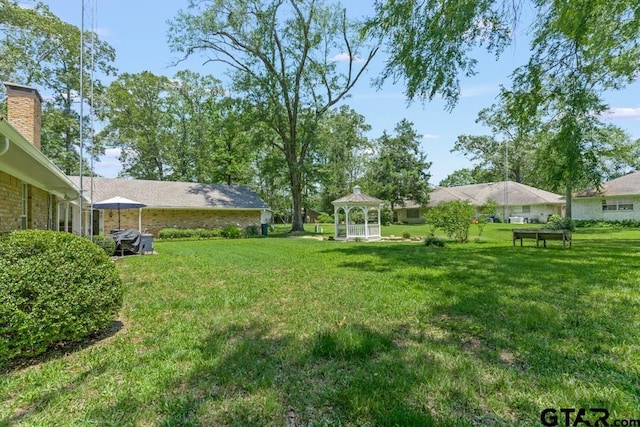1805 Greenway St, Gilmer, TX 75644 - view of grassy yard with a gazebo