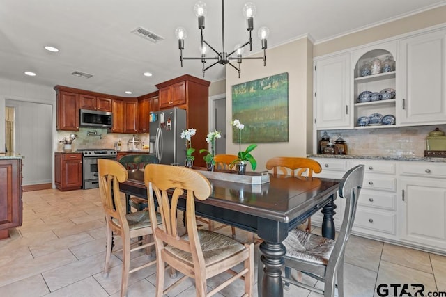 1805 Greenway St, Gilmer, TX 75644 - dining room with a chandelier, recessed lighting, ornamental molding, and light tile patterned flooring