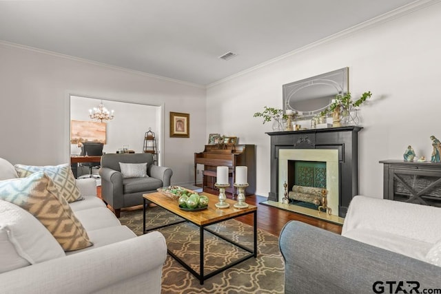 1805 Greenway St, Gilmer, TX 75644 - living area featuring crown molding, wood finished floors, a fireplace with flush hearth, and a chandelier