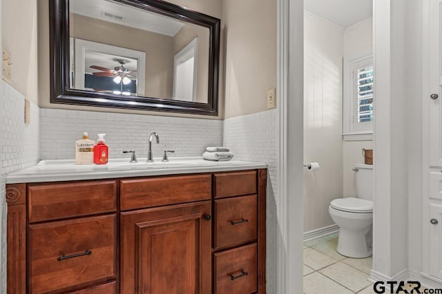 1805 Greenway St, Gilmer, TX 75644 - bathroom featuring vanity, toilet, tile patterned flooring, ceiling fan, and ornamental molding