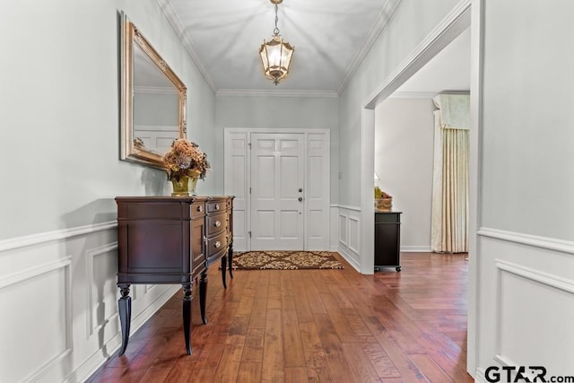 1805 Greenway St, Gilmer, TX 75644 - entrance foyer featuring hardwood / wood-style floors, ornamental molding, wainscoting, a chandelier, and a decorative wall