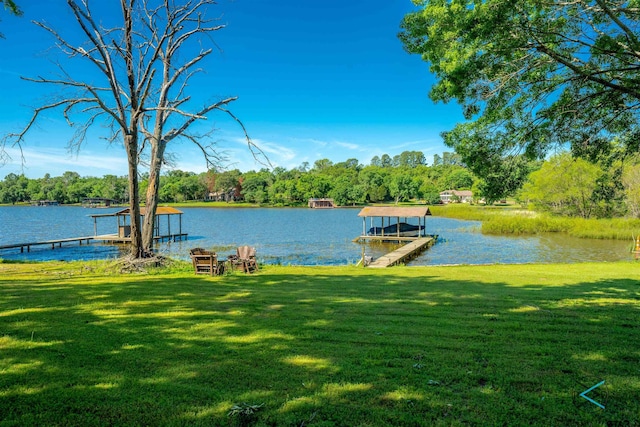 view of dock featuring a yard and a water view