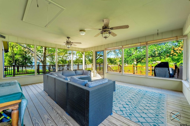 sunroom / solarium featuring ceiling fan