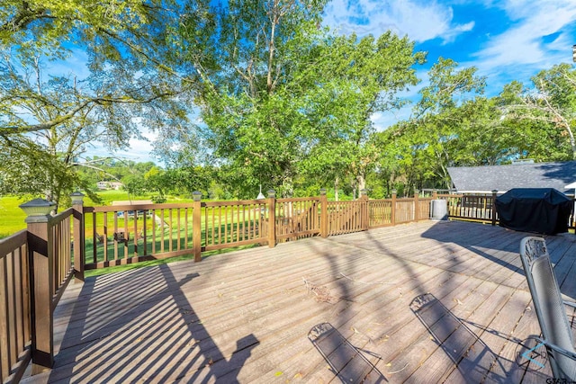 wooden deck with a grill