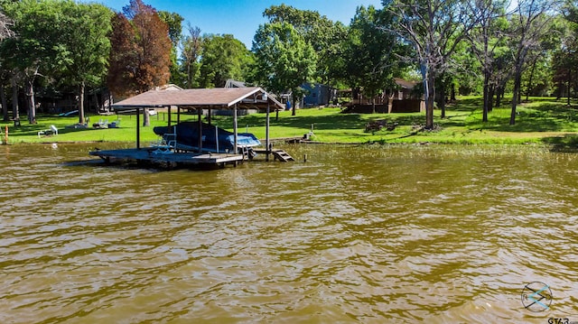 view of dock with a water view and a lawn