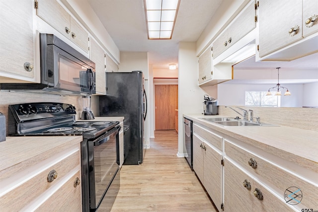 kitchen with black appliances, light wood-type flooring, backsplash, hanging light fixtures, and sink