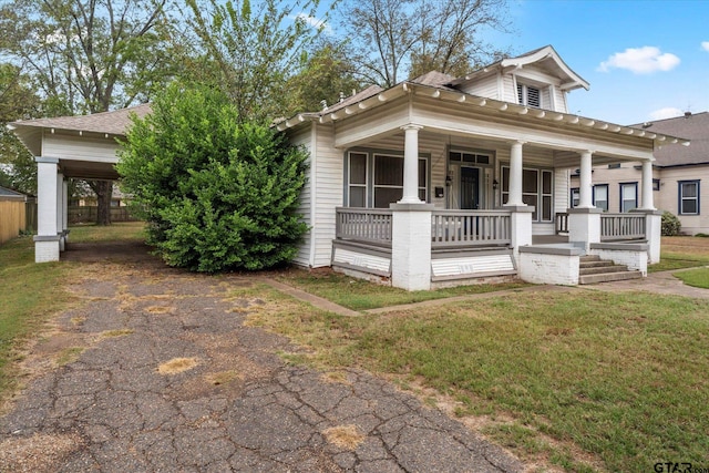 view of front of house featuring covered porch and a front lawn