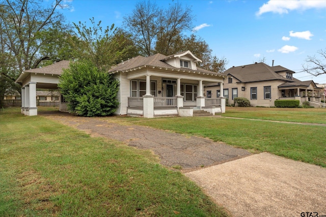 view of front of house featuring covered porch and a front lawn