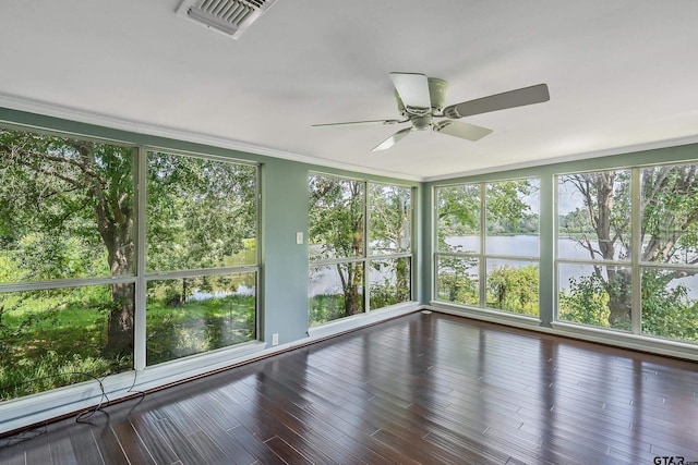 unfurnished sunroom featuring ceiling fan, plenty of natural light, and a water view