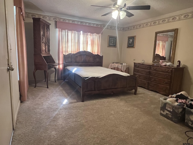 bedroom featuring ceiling fan, a textured ceiling, and carpet