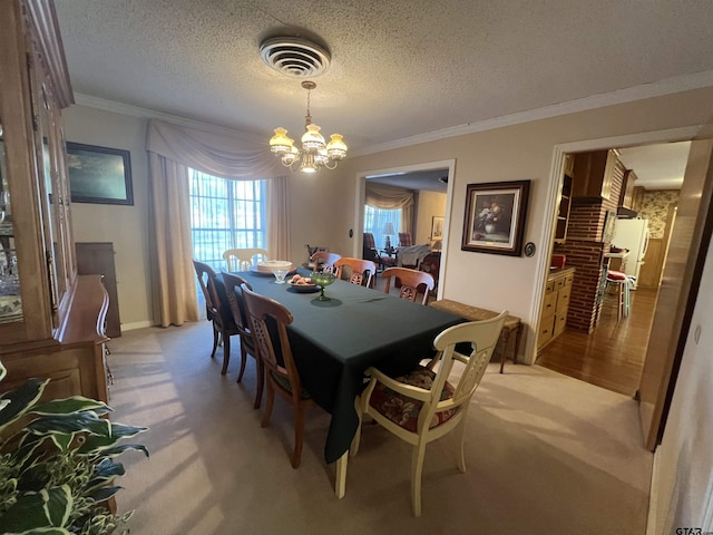 dining room featuring crown molding, light colored carpet, a textured ceiling, and an inviting chandelier