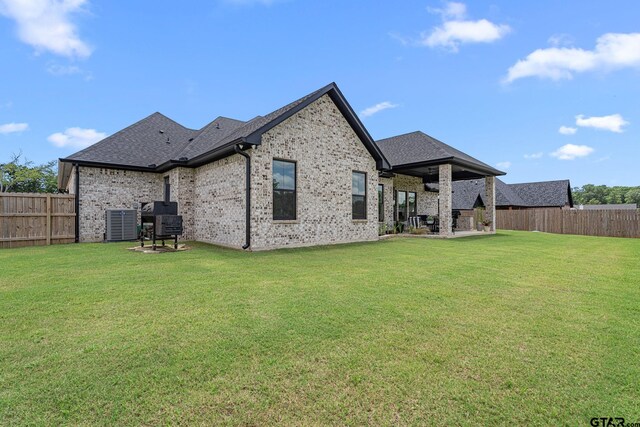 12293 Harlon St, Flint, TX 75762 - rear view of house with a fenced backyard, brick siding, roof with shingles, and a patio