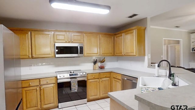 kitchen with visible vents, a peninsula, a sink, light countertops, and appliances with stainless steel finishes