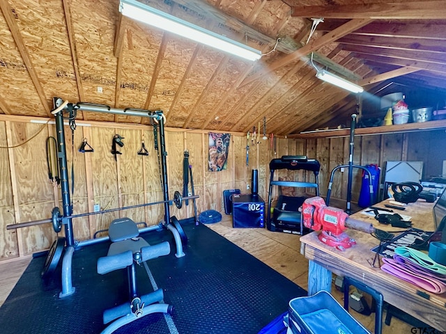 workout room with vaulted ceiling