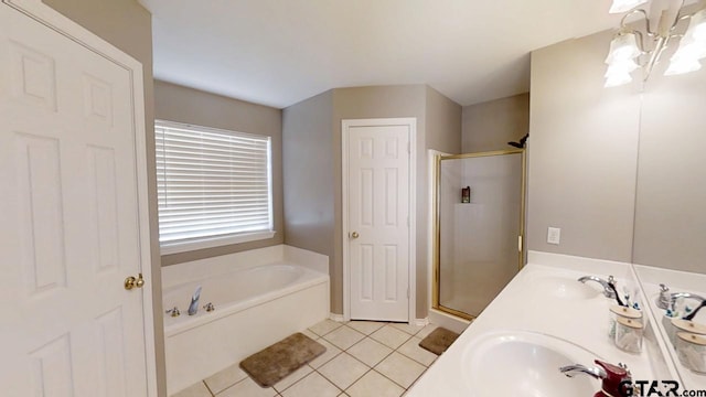 bathroom featuring tile patterned flooring, a shower stall, a bath, and a chandelier