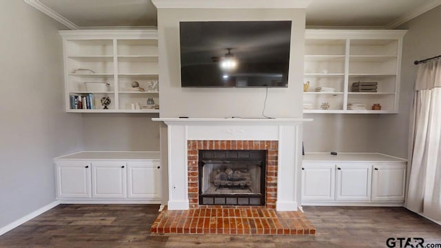 unfurnished living room with dark wood finished floors, crown molding, a brick fireplace, and baseboards