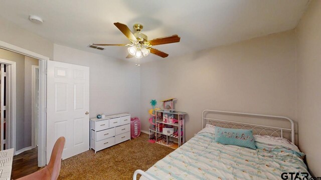 bedroom with visible vents, carpet flooring, and ceiling fan