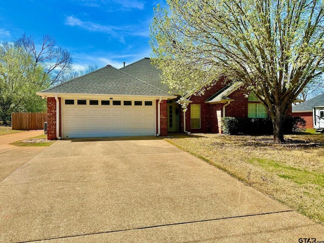 single story home with brick siding, driveway, and a garage