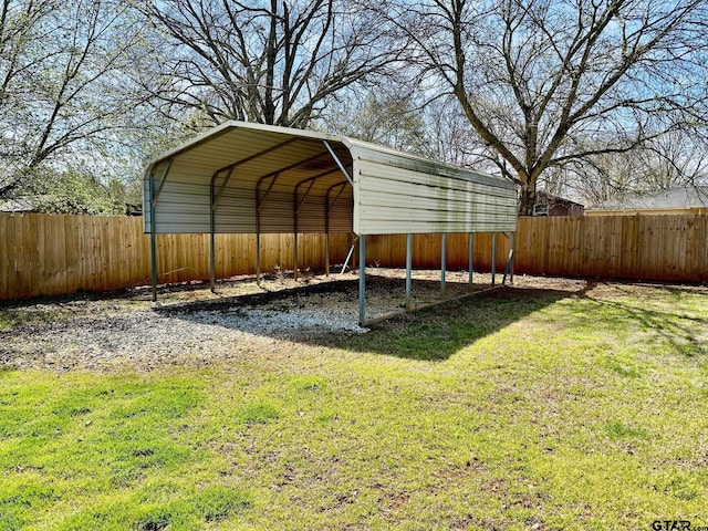 view of yard featuring a carport and fence