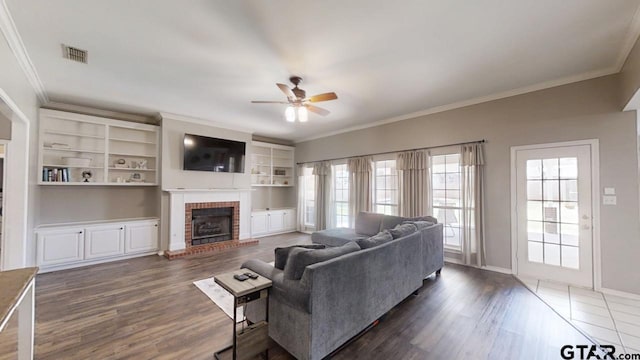 living area featuring crown molding, visible vents, dark wood-style flooring, and ceiling fan