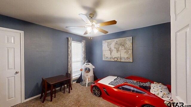 carpeted bedroom with a ceiling fan and baseboards