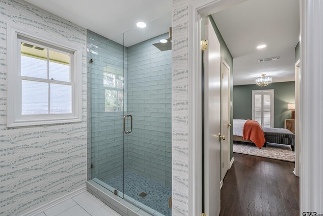 ensuite bathroom featuring ensuite bathroom, visible vents, baseboards, a shower stall, and wallpapered walls